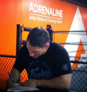 Chris Clements signing his new UFC contract at Adrenaline MMA in London